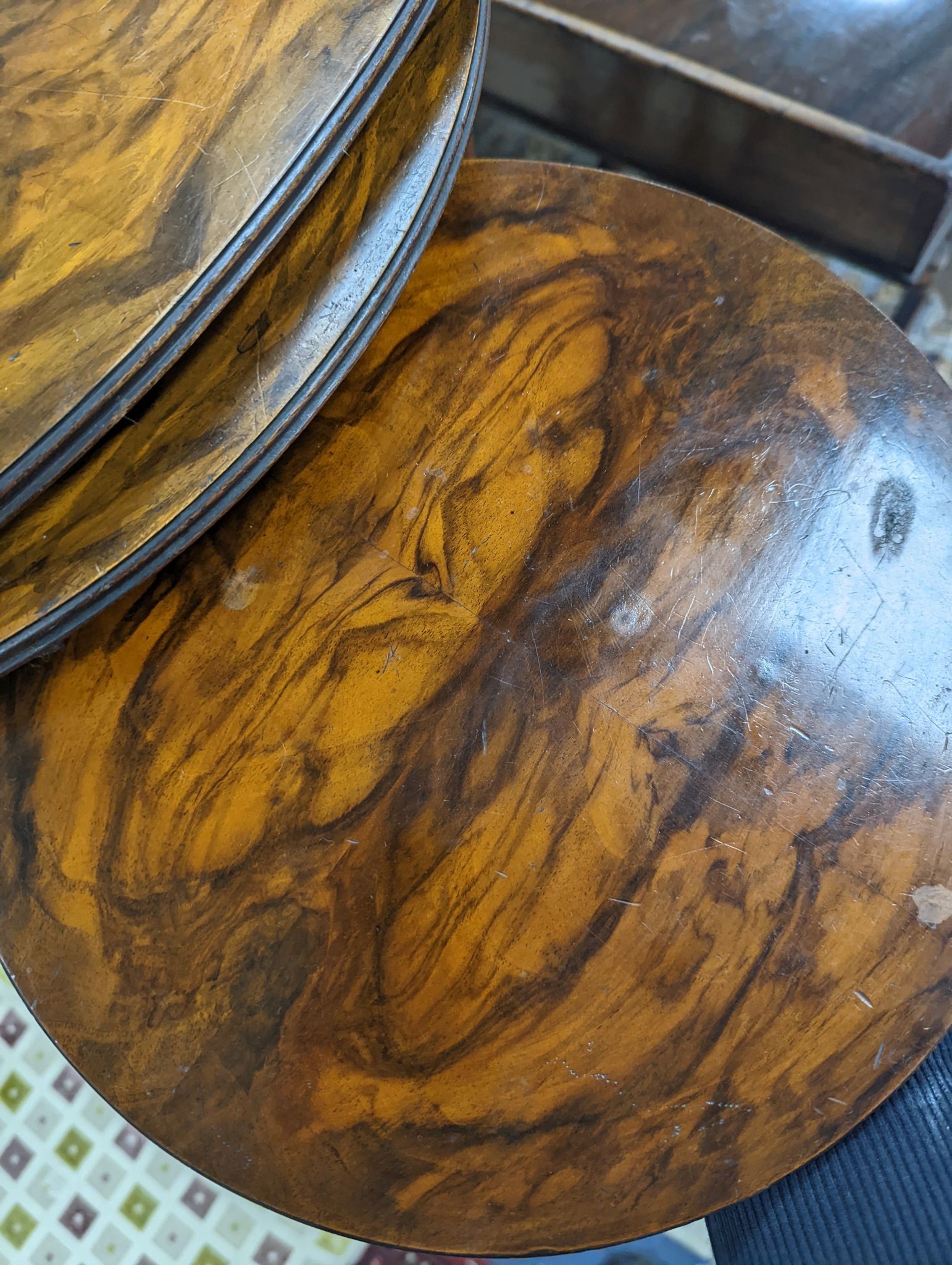 A nest of three oval and circular burr and simulated walnut tea tables, width 55cm, depth 37cm, height 60cm